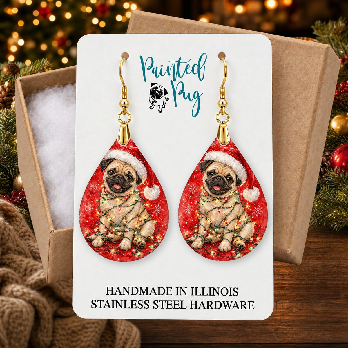 Fawn Pug Christmas Lights earrings in a gift box on a Christmas table
