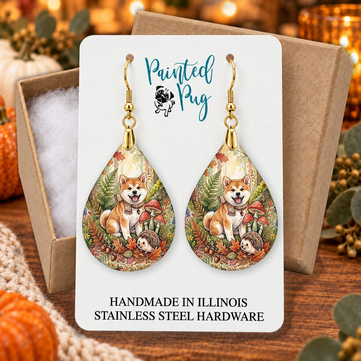 Akita woodland teardrop earrings gift boxed on a cozy fall background