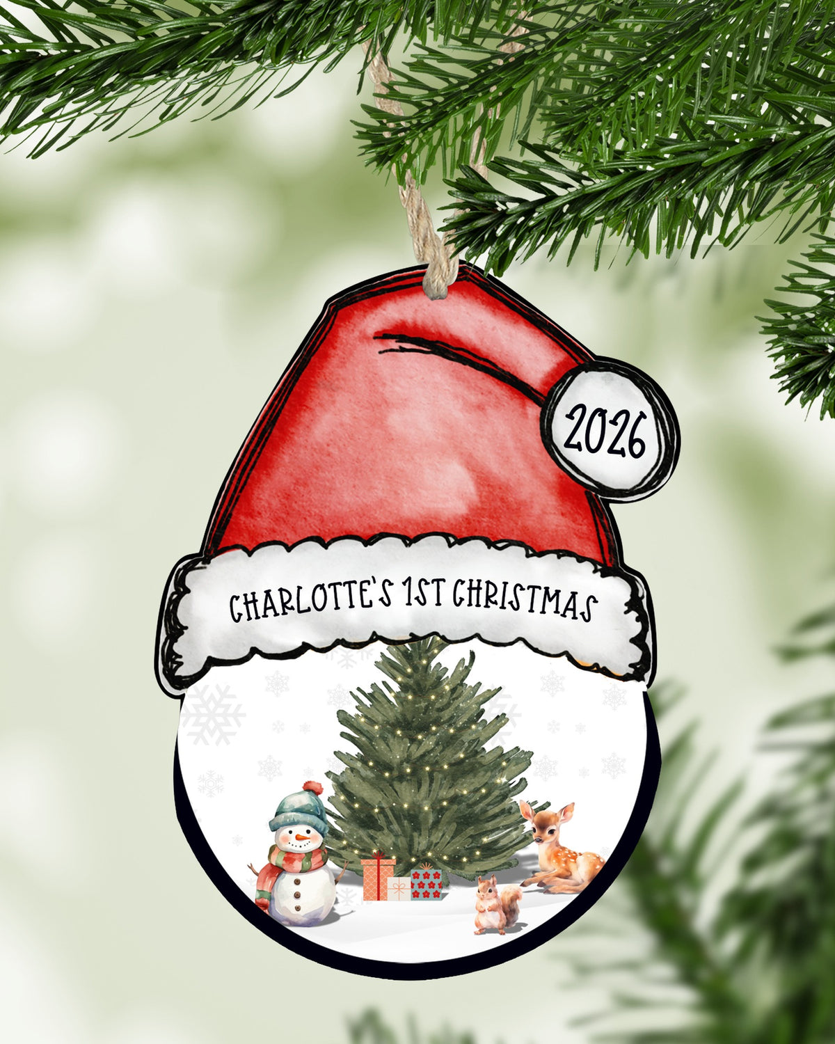 Personalized baby's first Christmas Santa hat ornament hanging on a Christmas tree - The Painted Pug