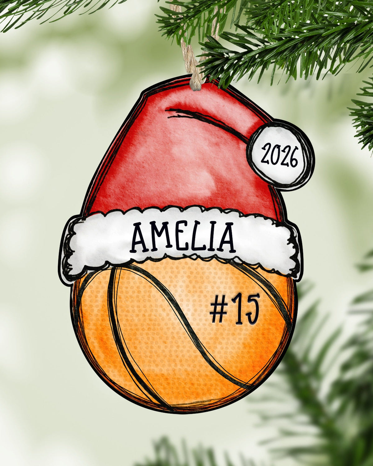 Personalized basketball Christmas ornament hanging on a Christmas tree - The Painted Pug
