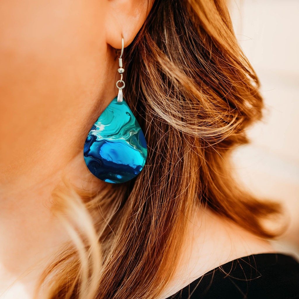 Blue Teal Paint Pour Teardrop Earrings close-up on model