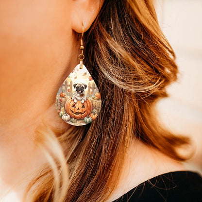 Fawn pug pumpkin teardrop earrings shown on a model