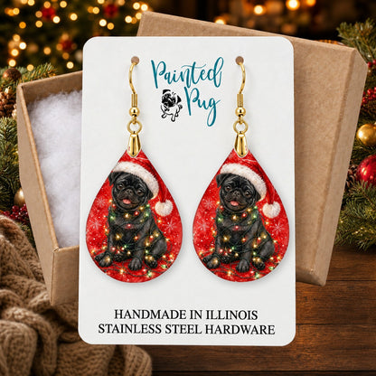 Black Pug Christmas Lights earrings in a gift box on a Christmas table