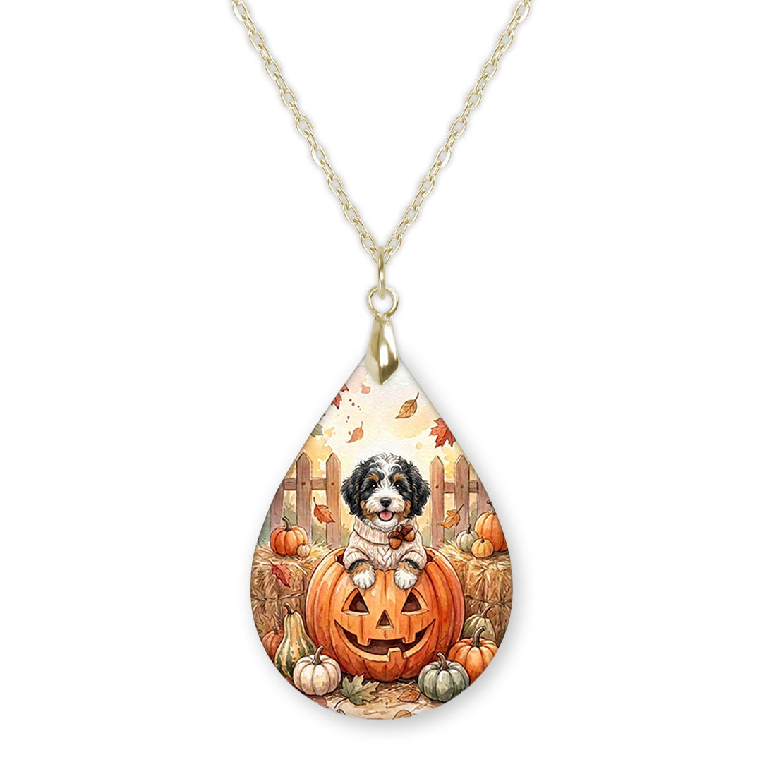 Bernedoodle in a jack-o-lantern teardrop necklace on a gold chain