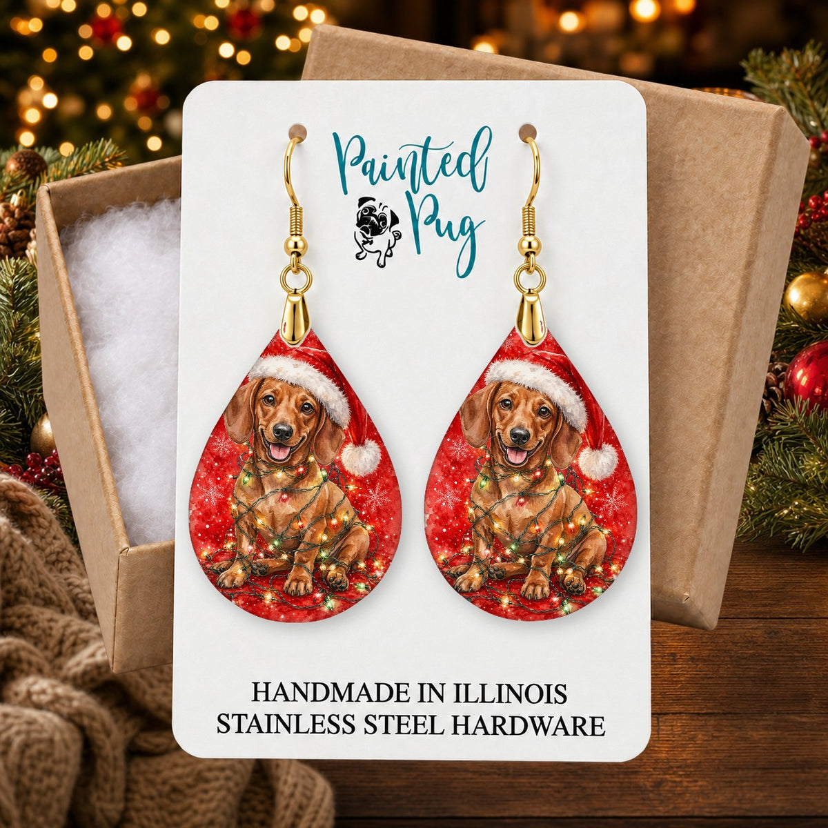 Dachshund Christmas Lights earrings in a gift box on a Christmas table