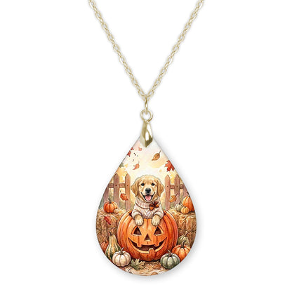 Golden retriever in a jack-o-lantern teardrop necklace on a gold chain
