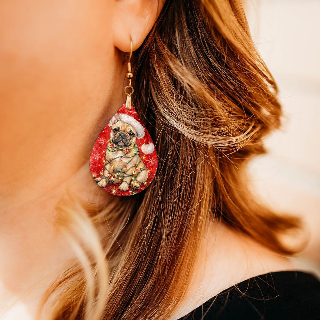Tan Frenchie Christmas Lights teardrop earrings worn by a model, close-up