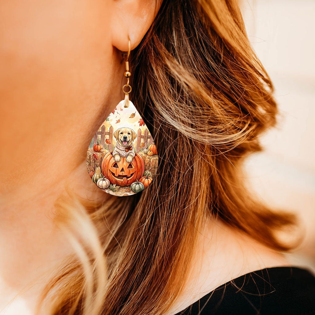 Model wearing yellow Lab pumpkin teardrop earrings