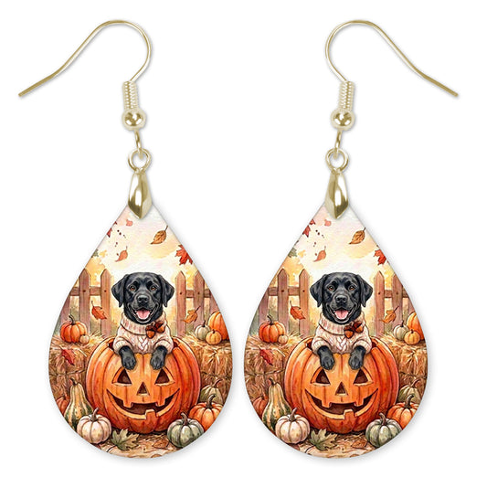 Black Lab in a cream sweater on a jack-o'-lantern teardrop earrings with gold-tone hooks
