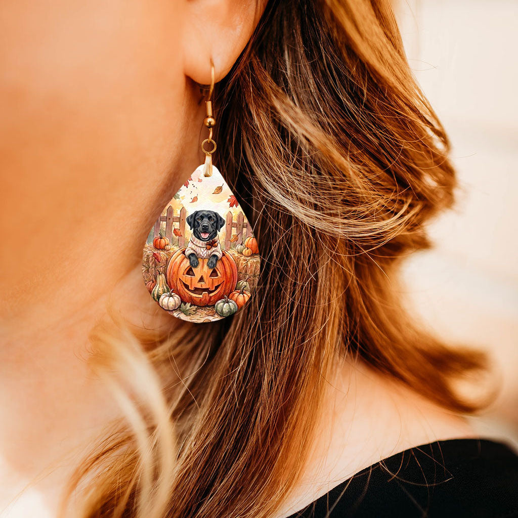 Model wearing black Lab pumpkin teardrop earrings