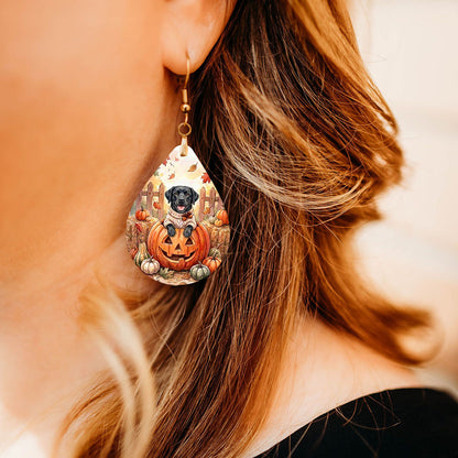 Model wearing black Lab pumpkin teardrop earrings