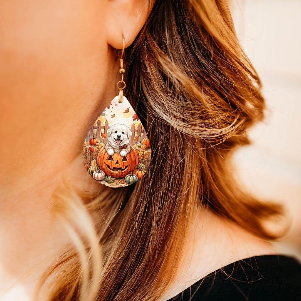 Model wearing Great Pyrenees pumpkin teardrop earrings