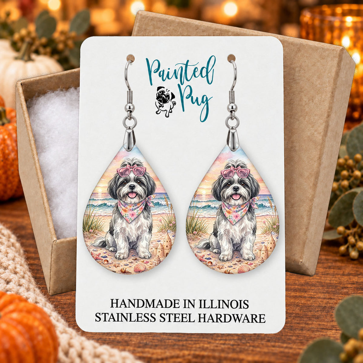 Black and White Shih Tzu beach teardrop earrings gift boxed on a seasonal background