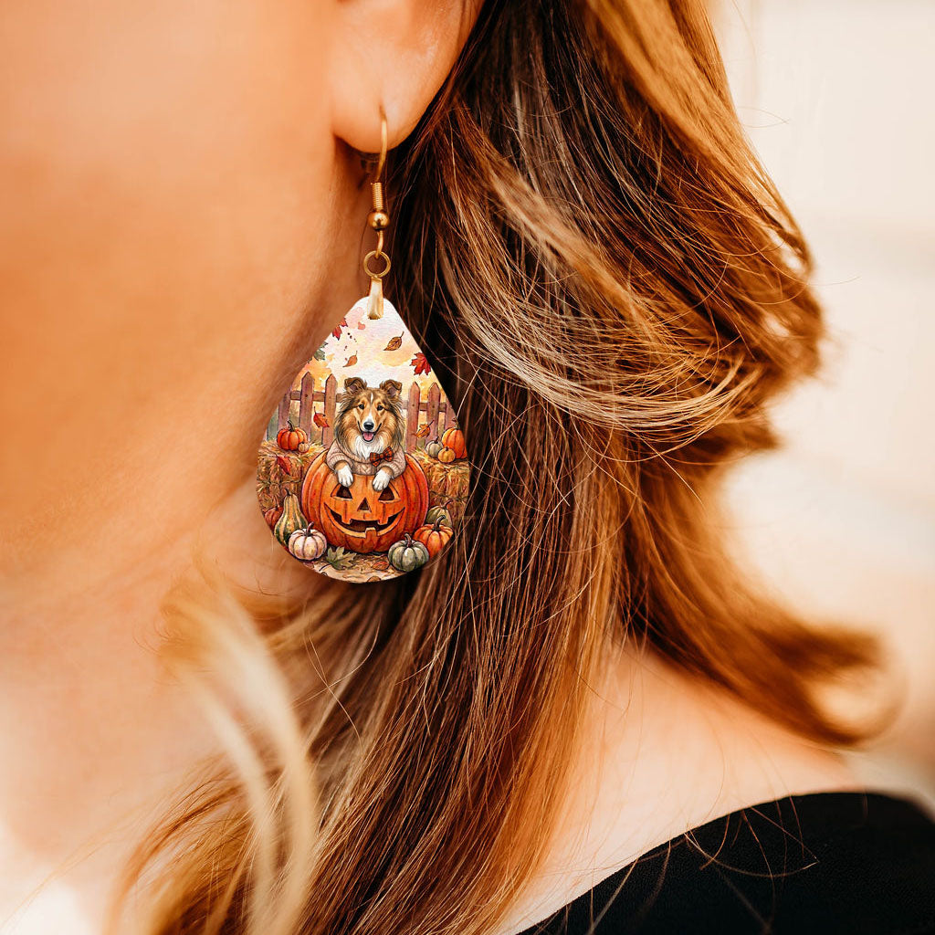 Model wearing collie pumpkin teardrop earrings