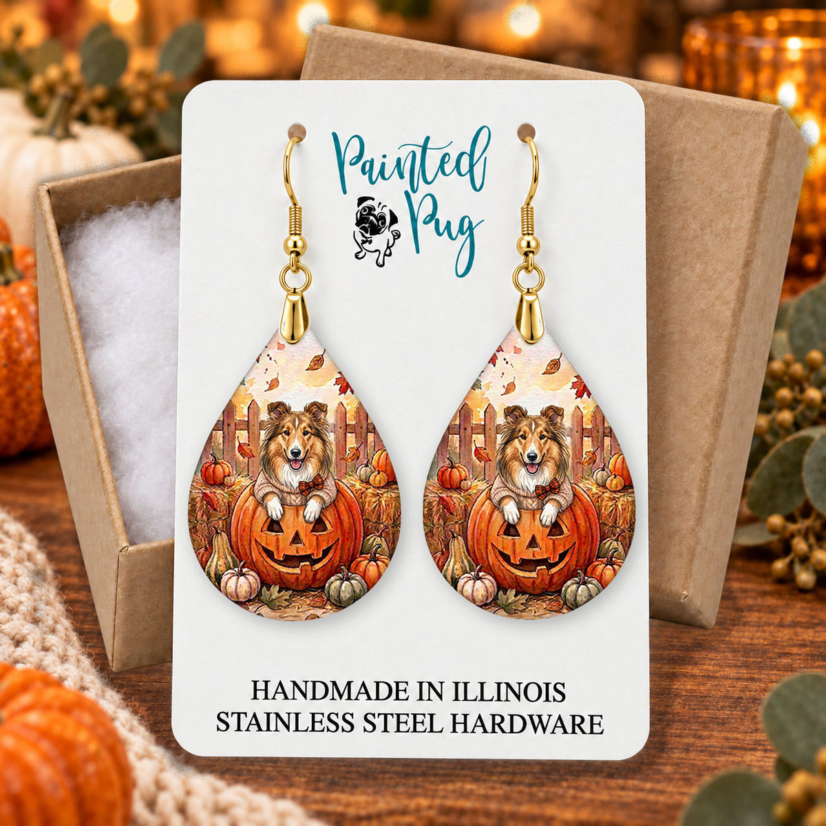 Collie pumpkin teardrop earrings gift boxed on a cozy fall background