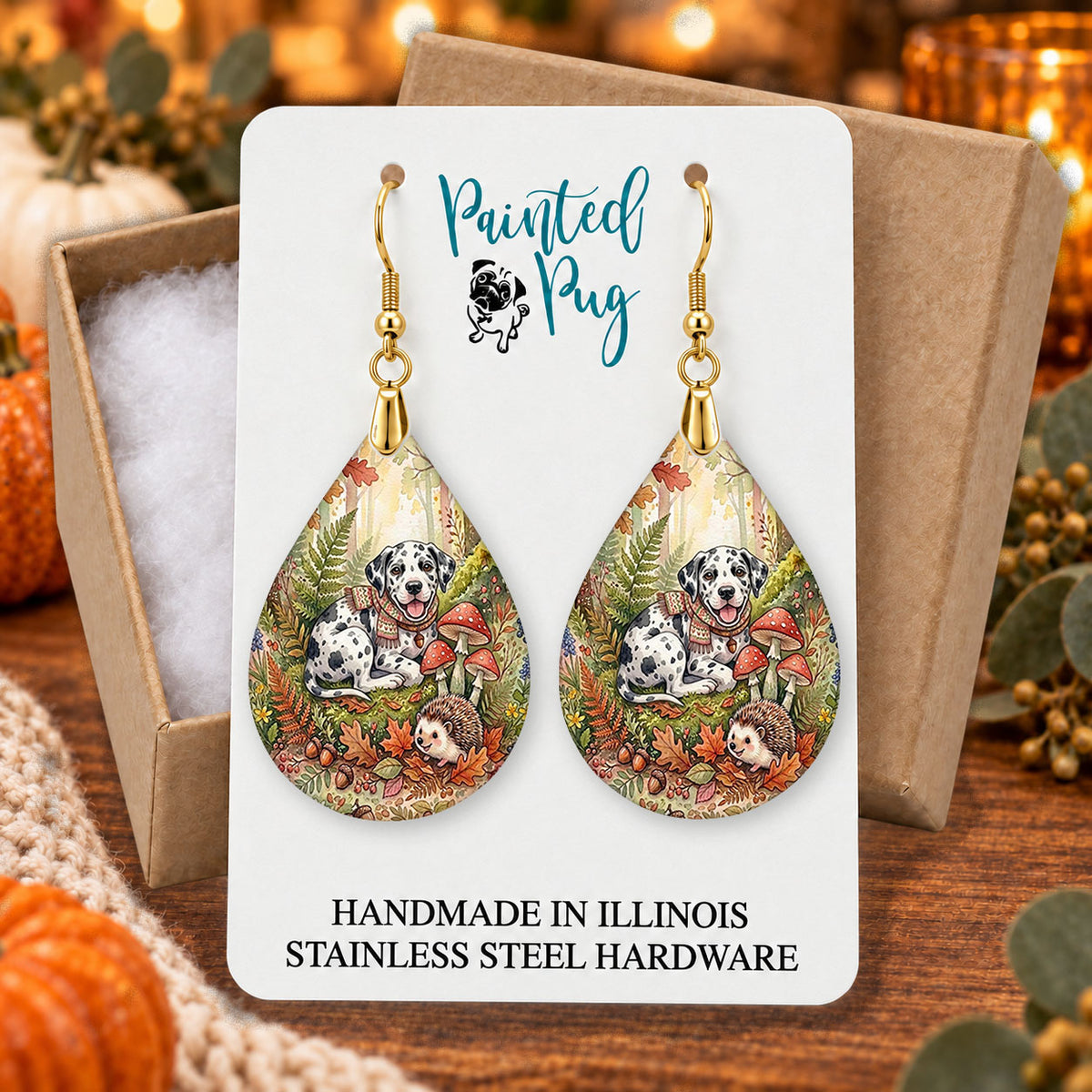 Harlequin Great Dane woodland teardrop earrings gift boxed on a cozy fall background