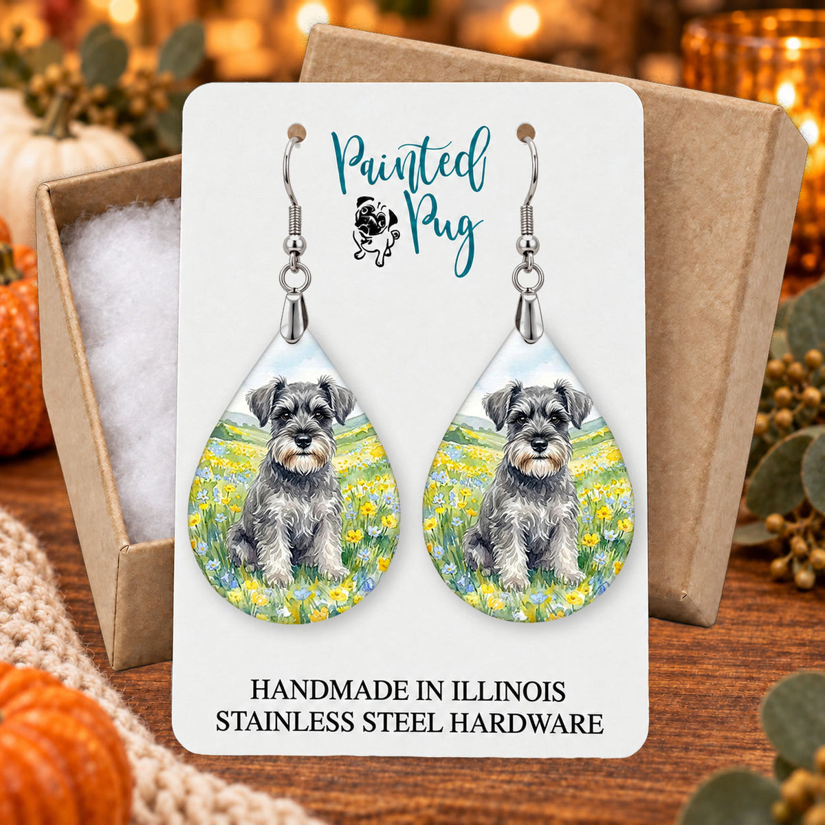 Schnauzer spring meadow teardrop earrings gift boxed on a seasonal background