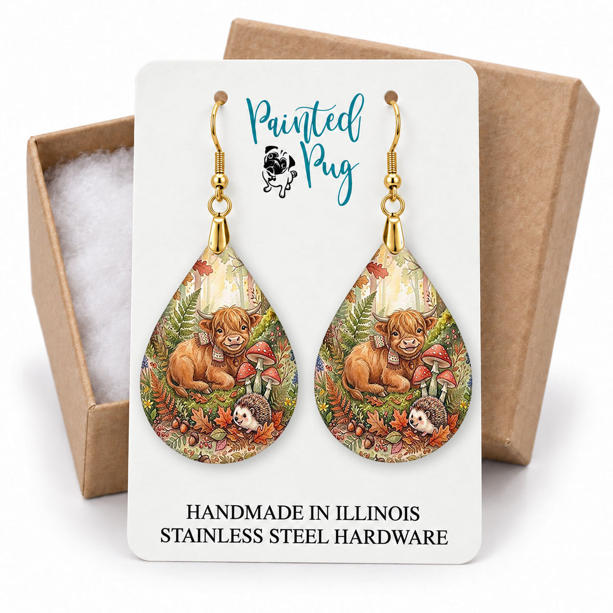 Highland Cow woodland teardrop earrings on a Painted Pug earring card with a kraft gift box