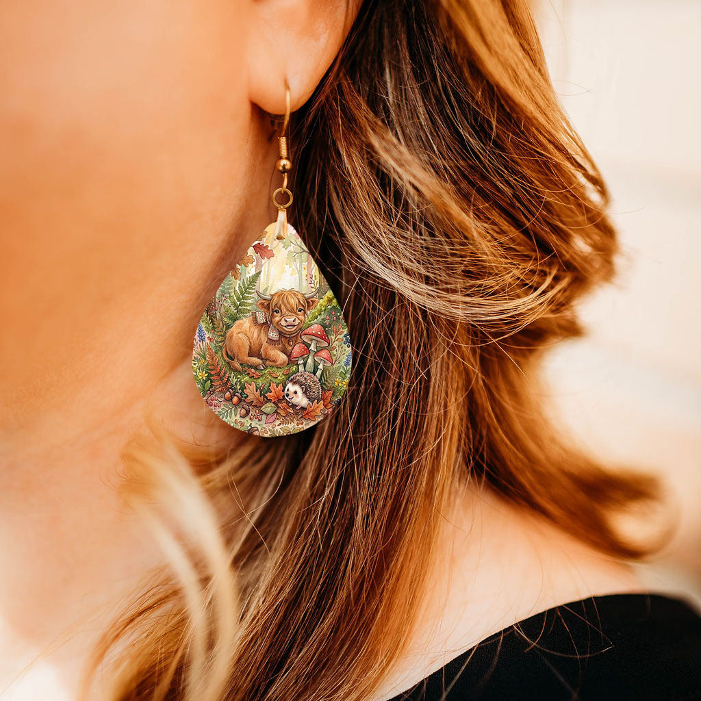 Model wearing Highland Cow woodland teardrop earrings