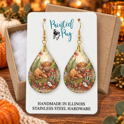 Highland Cow woodland teardrop earrings gift boxed on a cozy fall background