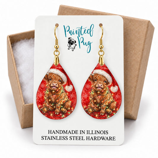 Highland Cow Christmas Lights teardrop earrings on a gift box card