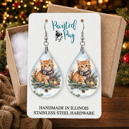 Tabby Cat Winter Woodland earrings in a gift box on a Christmas table