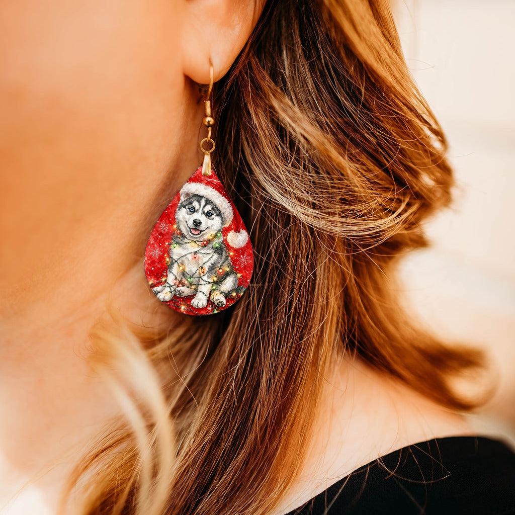 Husky Christmas Lights teardrop earrings worn by a model, close-up