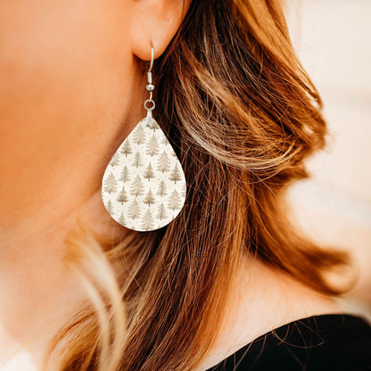 Model wearing neutral beige Christmas tree teardrop earrings