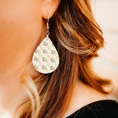 Model wearing Santa's sleigh and reindeer teardrop earrings