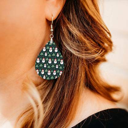 Model wearing snowman and Christmas tree teardrop earrings