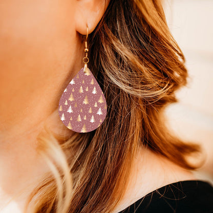 Model wearing pink and gold Christmas tree teardrop earrings