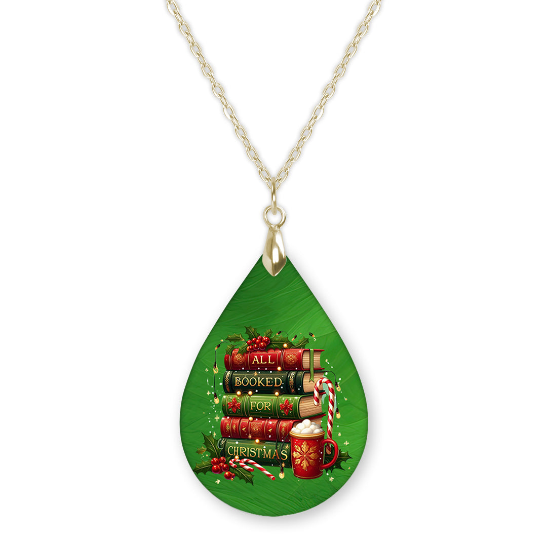 All Booked for Christmas book lover teardrop pendant necklace on a gold-tone chain