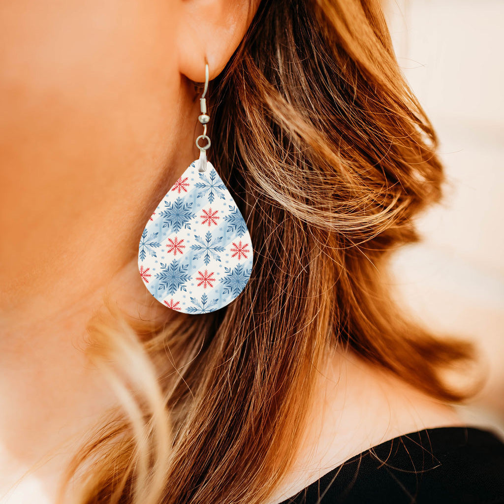 Model wearing blue and red snowflake teardrop earrings
