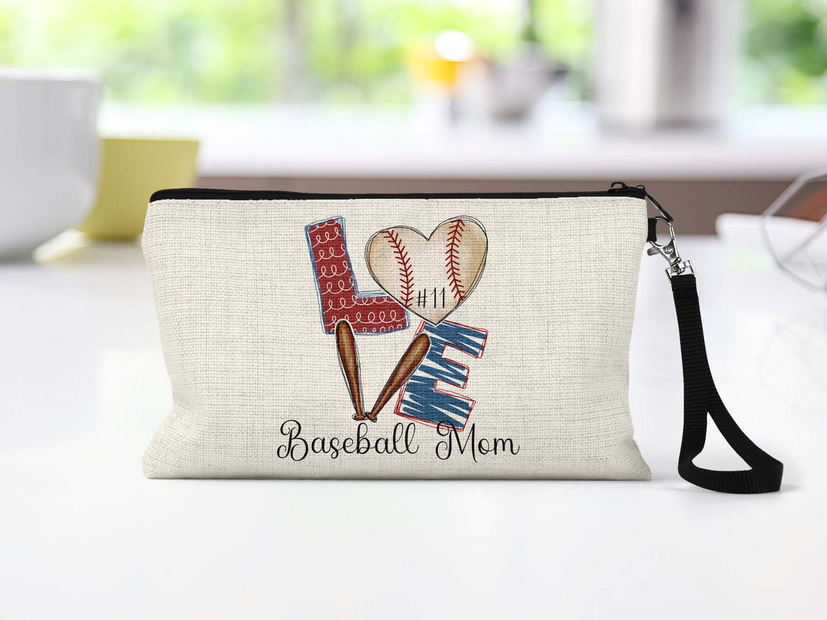 Baseball Mom heart and bats Makeup Bag on a kitchen counter