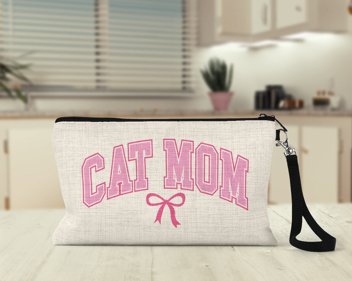 Cat Mom varsity bow Makeup Bag on a kitchen counter
