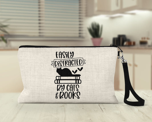 Easily Distracted by Cats and Books Makeup Bag on a desk