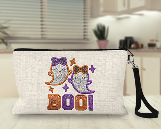 Boo orange and purple glitter ghosts Makeup Bag on a kitchen counter