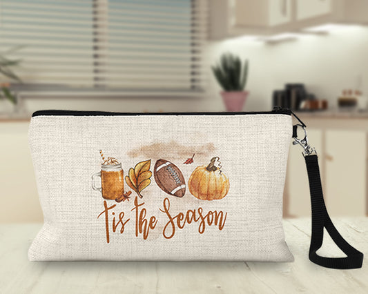 Tis the Season watercolor latte and football Makeup Bag on a kitchen counter