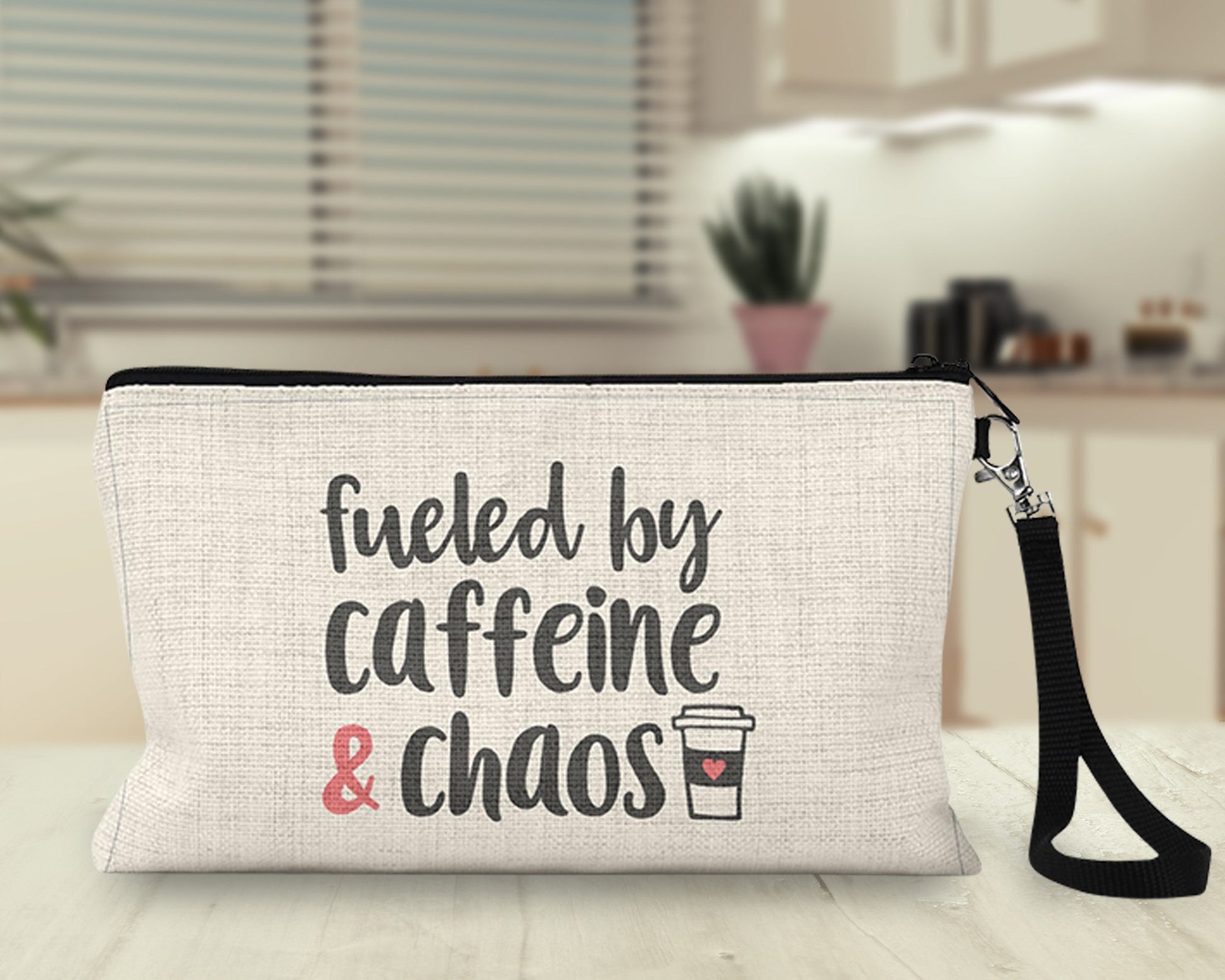 Fueled by Caffeine and Chaos Makeup Bag on a desk