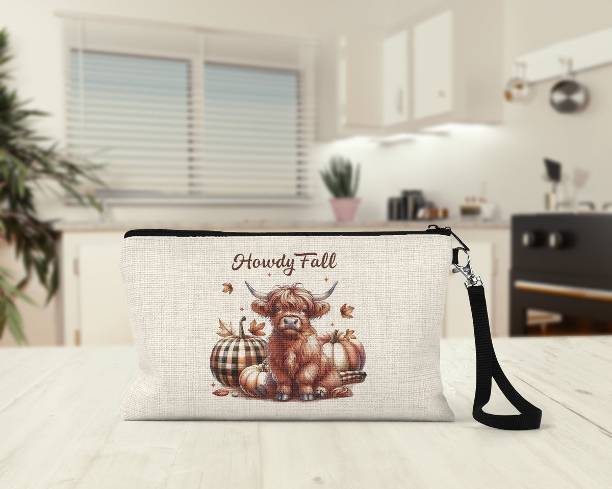 Howdy Fall Highland Cow Makeup Bag on a kitchen counter