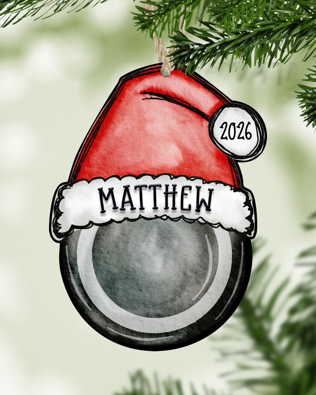 Personalized hockey Christmas ornament hanging on a Christmas tree - The Painted Pug