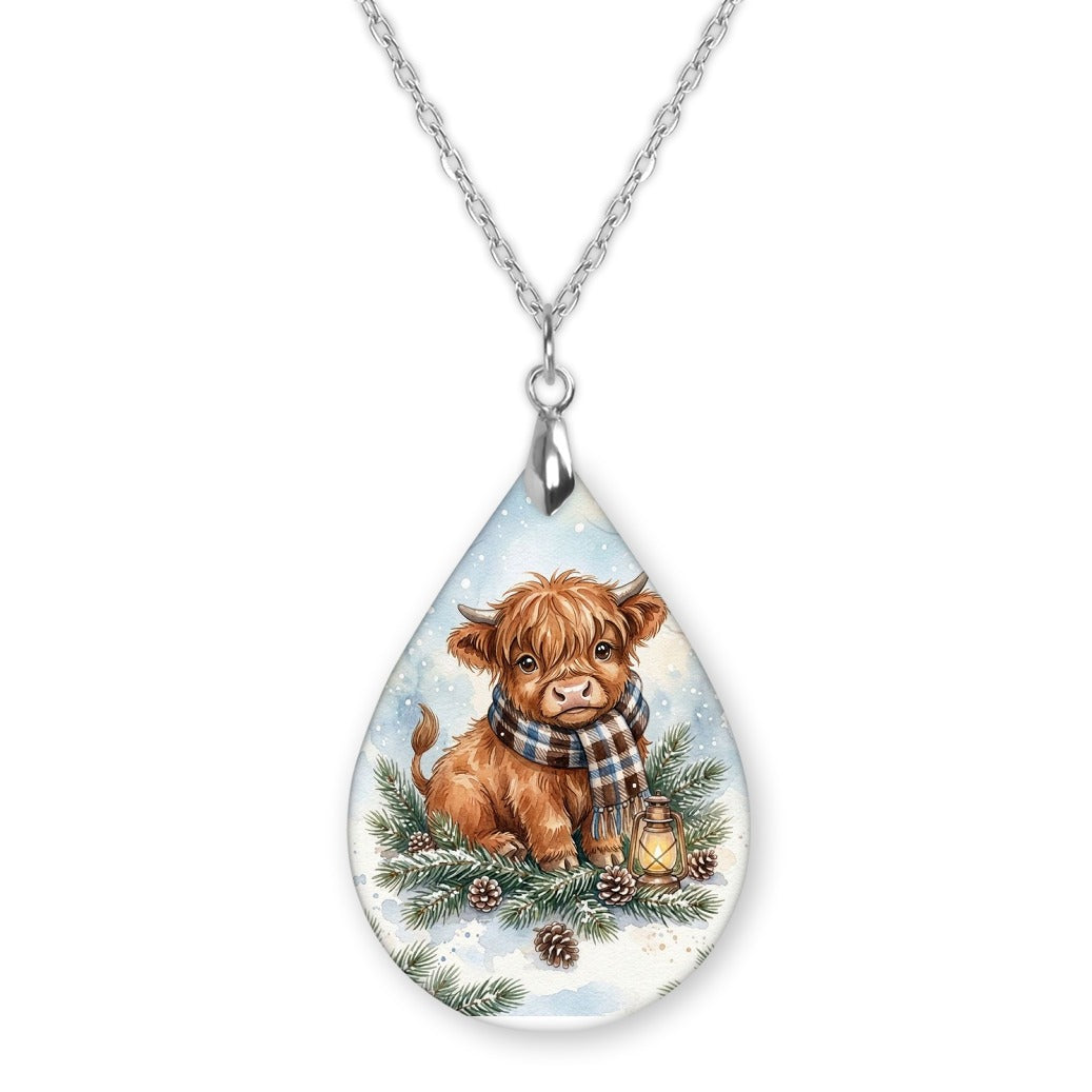 Highland Cow Winter Woodland teardrop pendant necklace on a silver-tone chain
