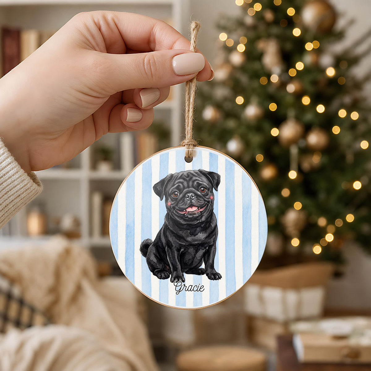 Personalized Black Pug ornament held in hand to show its 3 inch size