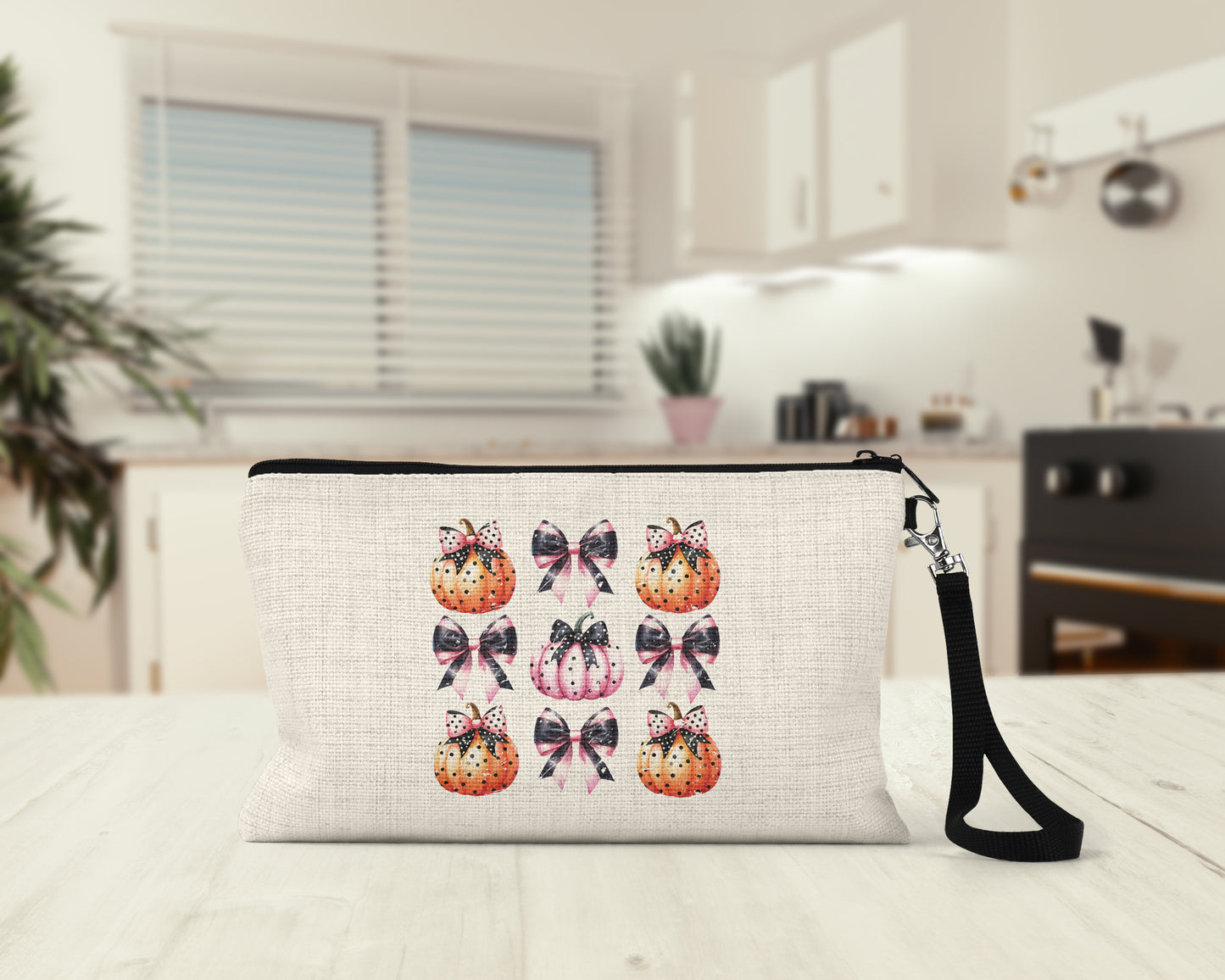 Pink Coquette Pumpkins and Bows Makeup Bag on a kitchen counter