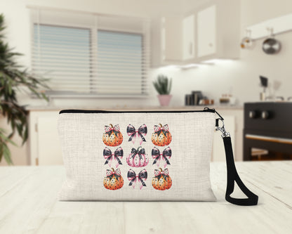 Pink Coquette Pumpkins and Bows Makeup Bag on a kitchen counter