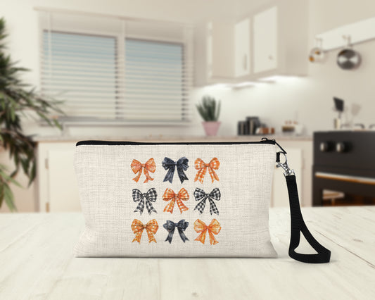 Orange and Black Bows Makeup Bag on a kitchen counter