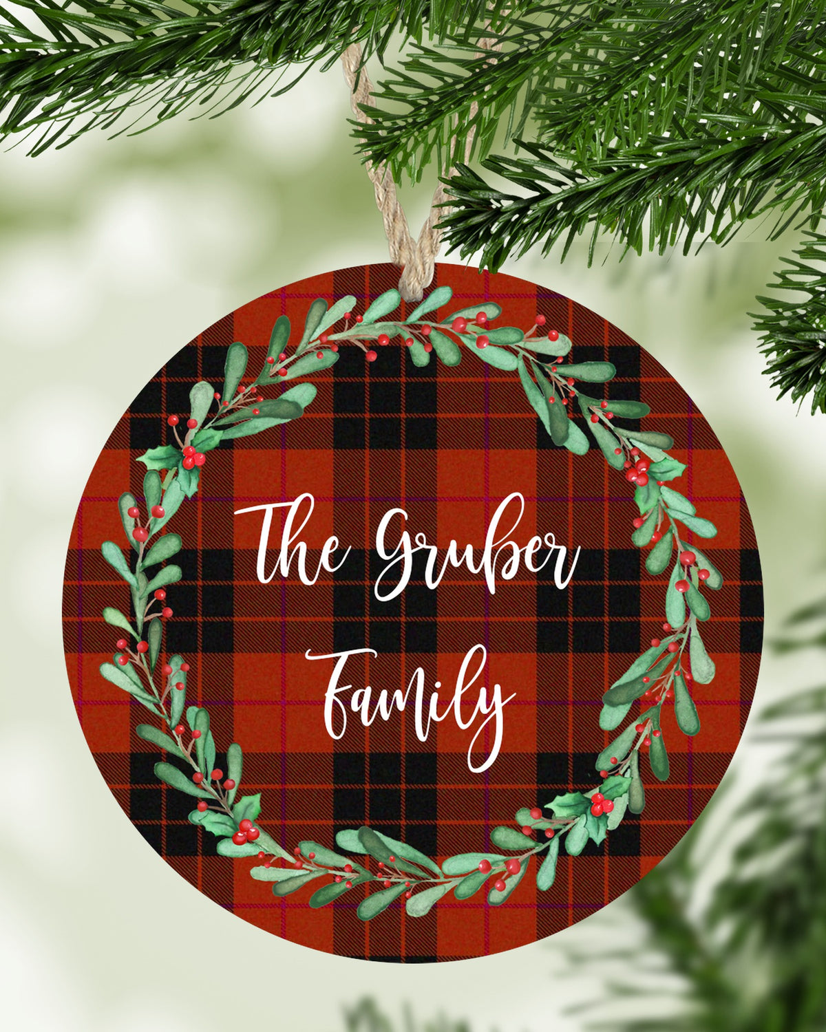 Personalized family name red plaid wreath Christmas ornament hanging on a Christmas tree - The Painted Pug