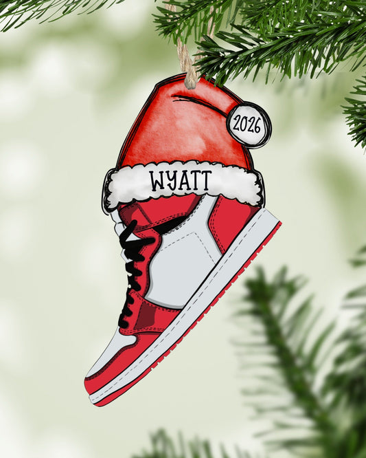 Personalized sneaker Christmas ornament in red, white and black hanging on a Christmas tree - The Painted Pug