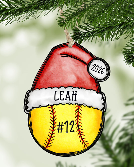 Personalized softball Christmas ornament hanging on a Christmas tree - The Painted Pug