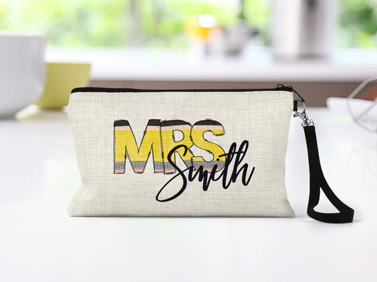 Personalized teacher pencil letters Makeup Bag on a counter